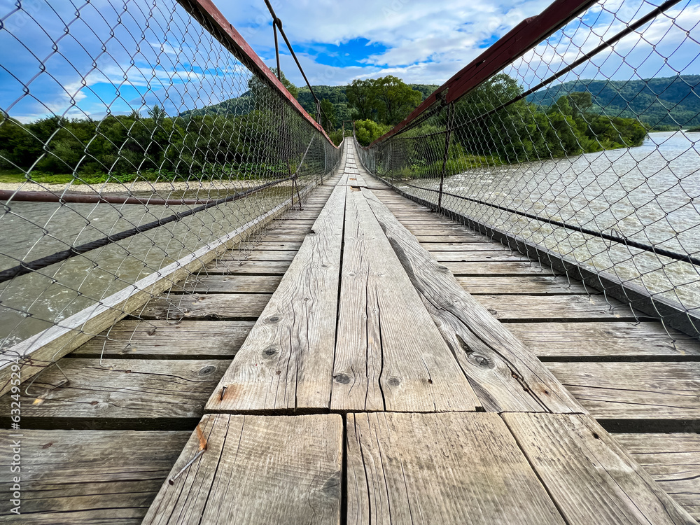 Obraz premium A wonderful view of the river in the Carpathians. Summer season in the mountains. Landscape with a river and mountains in the background