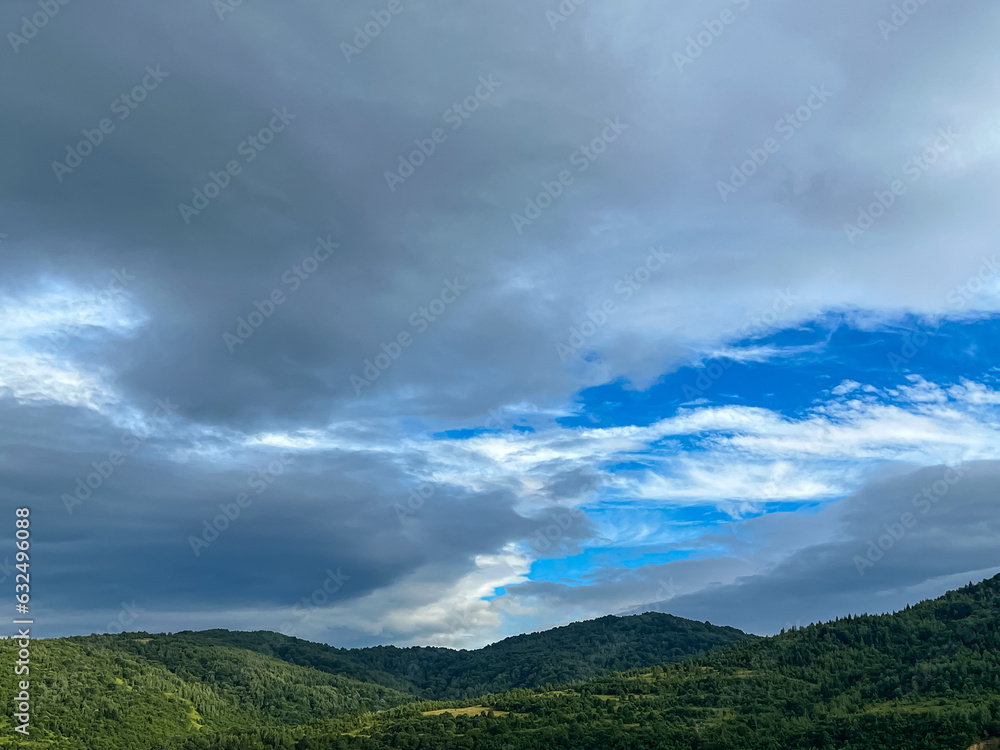 Awesome Carpathian mountains landscape background with forest and clouds on the summer season  