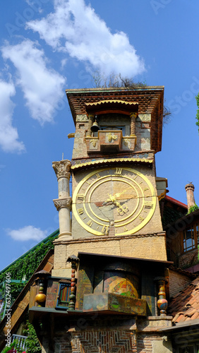 The Old Clock Tower of Tbilisi: A Symbol of the City's History and Culture in the heart of the City old Tbilisi in Georgia. yellow x gold with angle ringing the bell 
