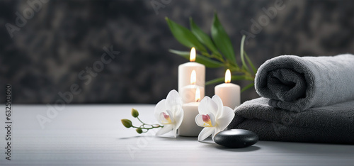 spa treatment background. towels with candles and flowers. banner with copy space