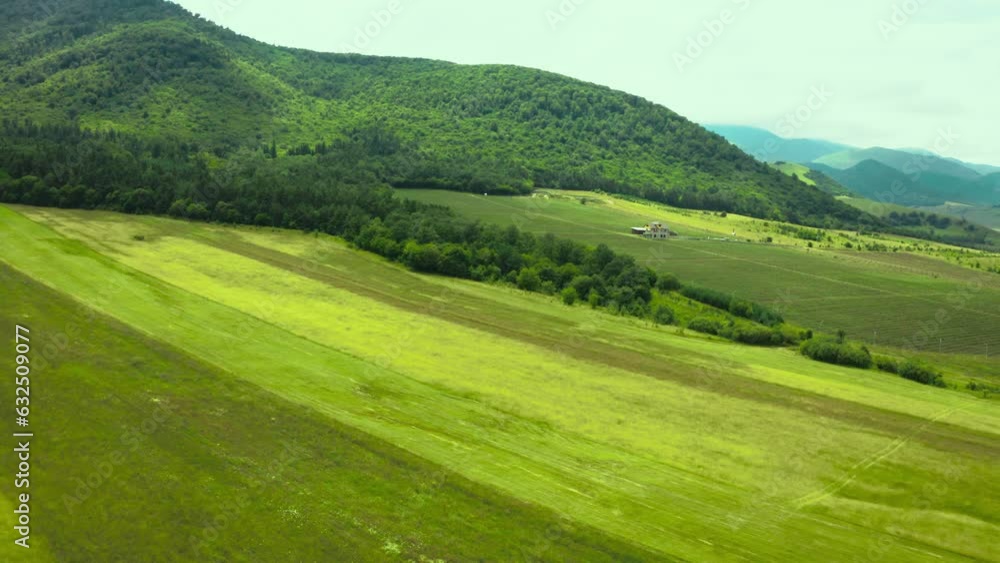Aerial video view from drone on natural landscape mountain pass under blue sky and clouds. Rural country road among meadow fields. 4k video Aerial video view from drone on natural landscape mountain pass under blue sky and clouds. Rural country road among meadow fields. 4k video