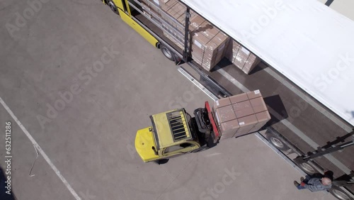 Aerial video of forklift loads a truck