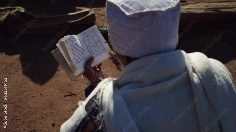 Priest praying with a bible Amhara Region Lalibela Ethiopia Priest praying with a bible Amhara Region Lalibela Ethiopia