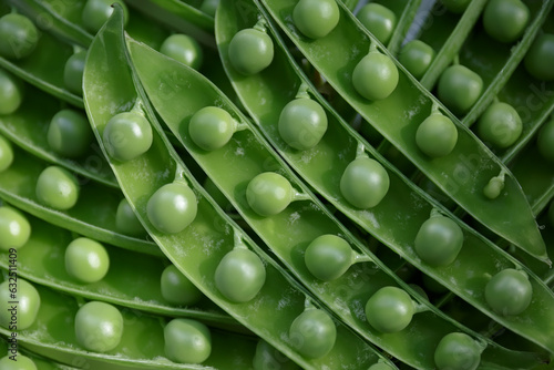 Grains of green young peas in open pods. Harvest of ripe fresh peas.