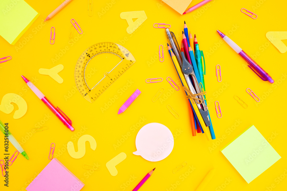 back to school or office styed desktop pattern with multicolored school supplies on yellow back ground with math formulas back to school or office styed desktop pattern with multicolored school supplies on yellow back ground with math formulas
