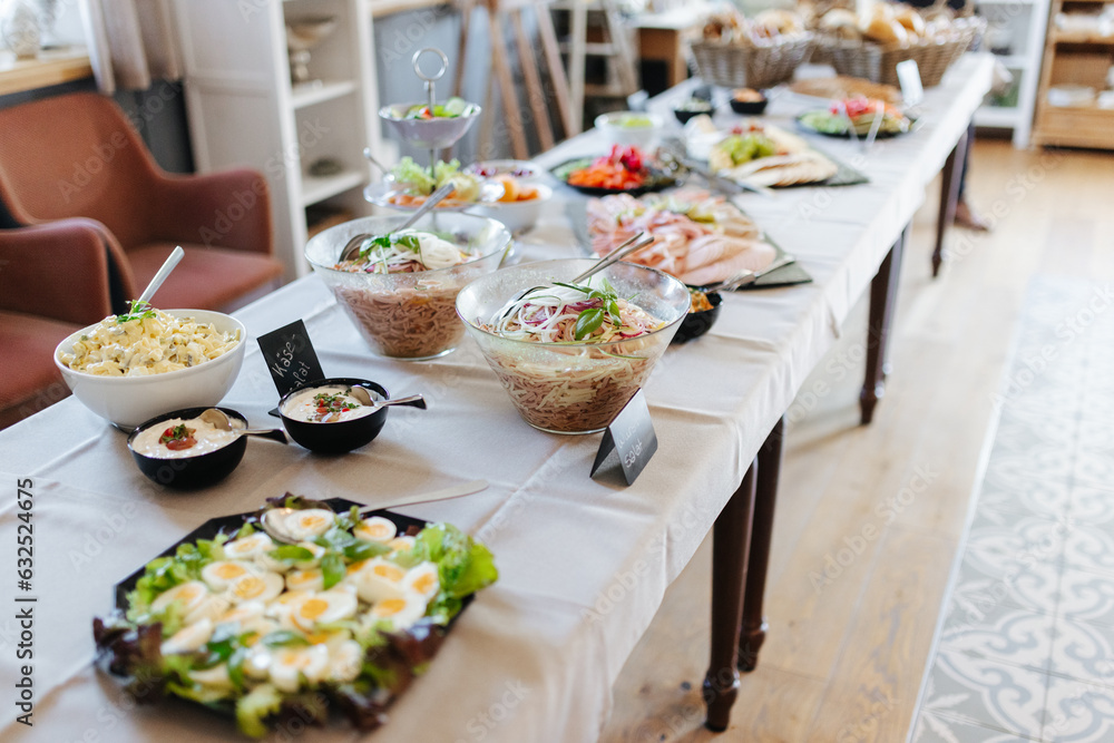 Buffet with salads, meats, and cheeses at a German wedding reception
