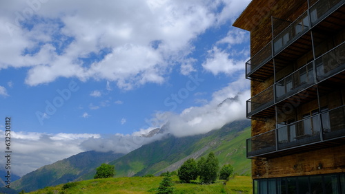 A View to Infinity: The Kazbegi Mountains Rise Above the Clouds, surrounding the small town of Kazbegi Mkinvartsveri in Georgia in a cloudy day in summer, Gudauri gergeti trinty church, ananuri