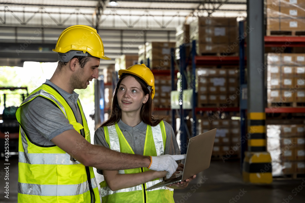 Warehouse man and woman workers with notebook working in manufacturing contribution factory warehouse Warehouse man and woman workers with notebook working in manufacturing contribution factory warehouse