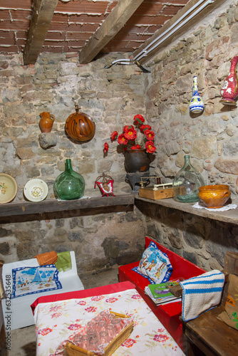 View of a dining room with old objects in a Catalan farmhouse, vertically