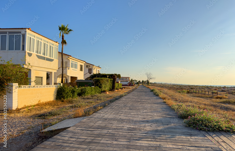 House at sea with pavement road. Suburb house building Exterior. Villa at seaside for holiday. Facade of house with Garden. House Exterior at coast. Residential home building for vacation on sea.
