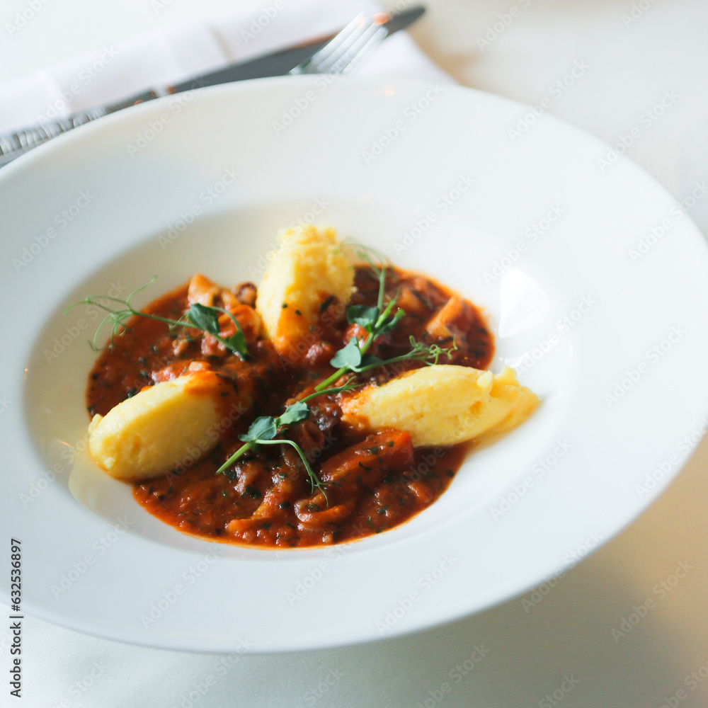 Traditional polenta served with tomato sauce Traditional polenta served with tomato sauce