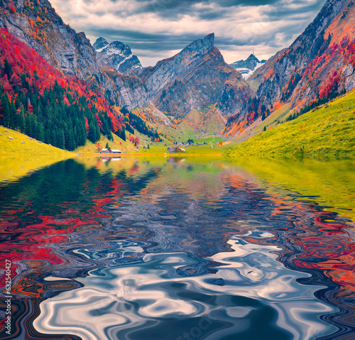 Alpswith Santis peak reflected in the calm waters of Seealpsee lake. Calm autumn scene of Swiss  Alps. Colorful morning view of Switzerland. Beauty of nature concept background, . photo