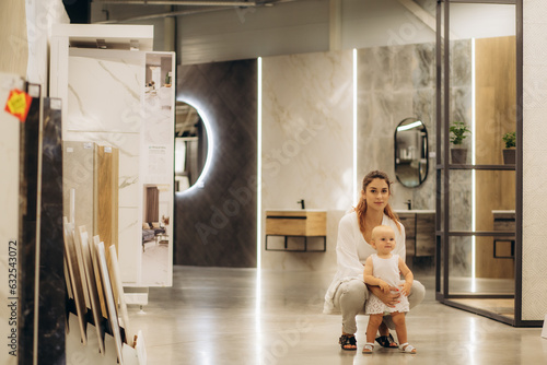 mother and daughter are walking around the hardware store © Roman