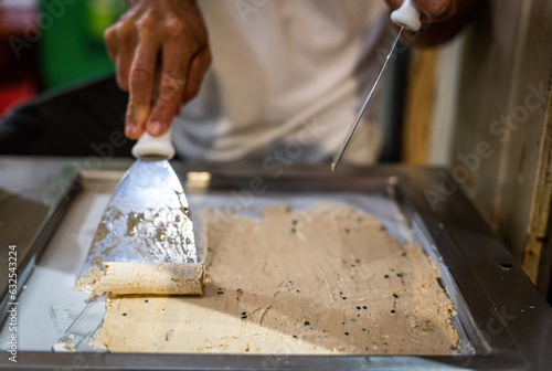 Passion Fruit Ice Cream Being Prepared on a Cold Steel Plate