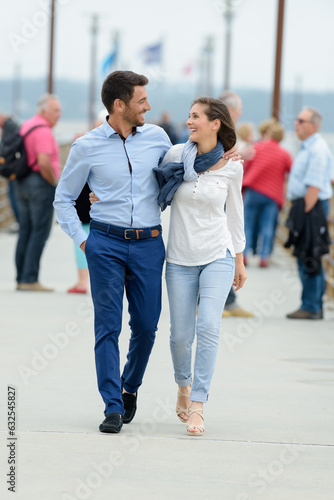 young couple walking on the pier