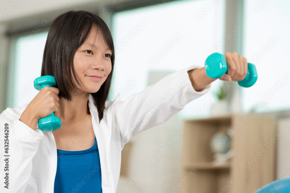 happy young woman with dumbbells working out happy young woman with dumbbells working out