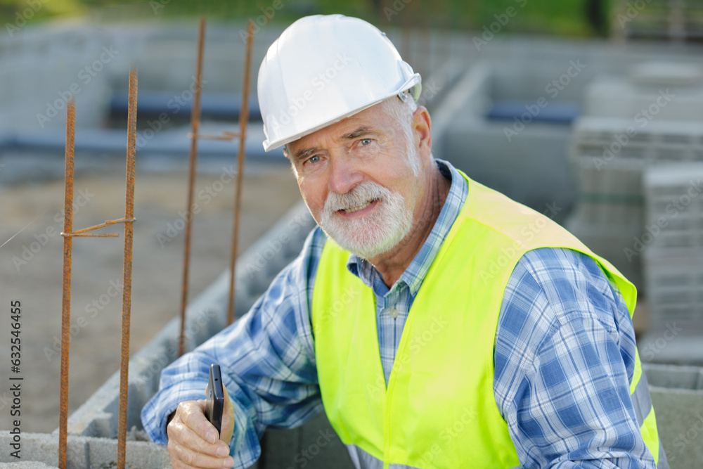 portrait of skilled professional bricklayer wearing helmet portrait of skilled professional bricklayer wearing helmet