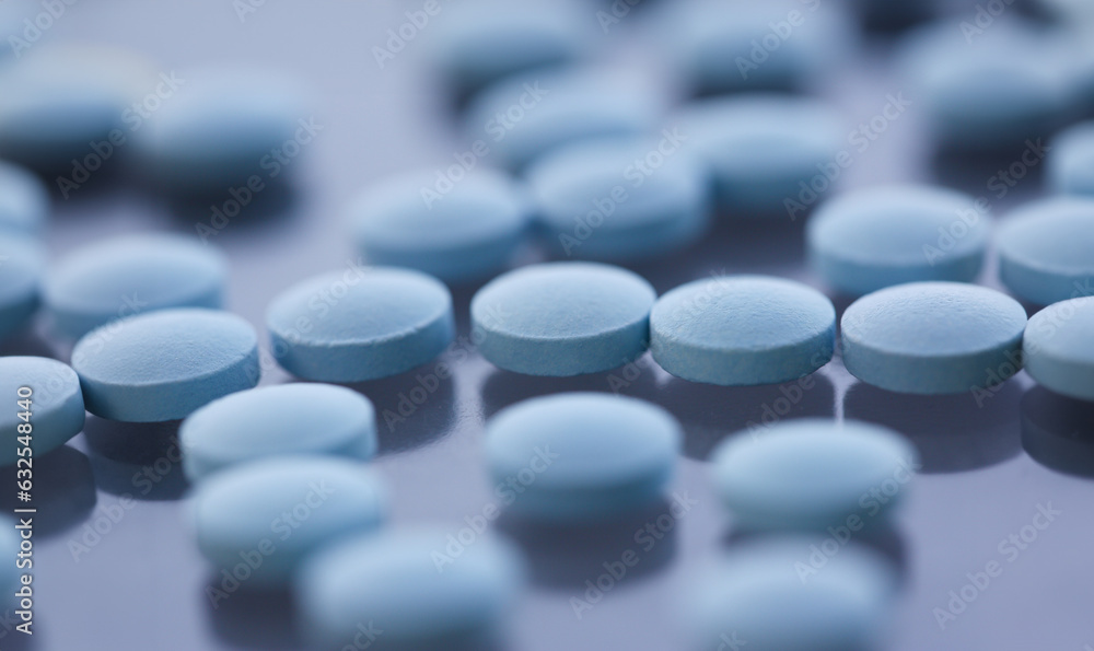 Tablets scattered blue color on the table of pharmaceutical laboratory pill for the prescription and treatment various diseases chemistry Tablets scattered blue color on the table of pharmaceutical laboratory pill for the prescription and treatment various diseases chemistry