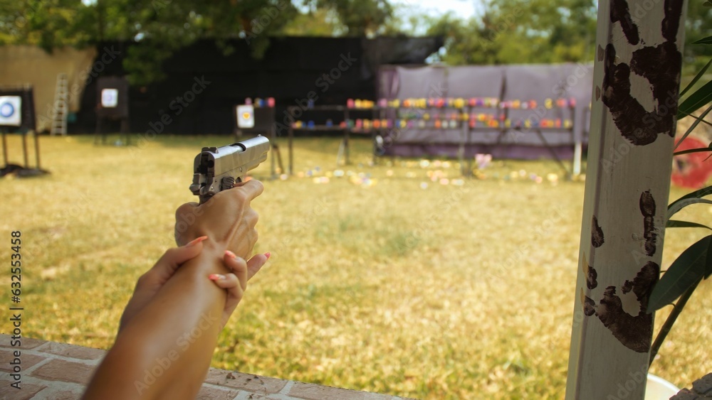 Tourist shoots at shooting range with pneumatic gun. Outdoors ...