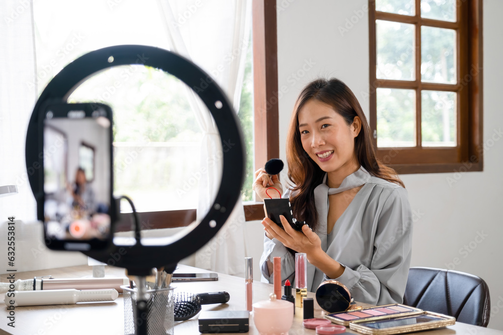 Woman live streaming while applying makeup.