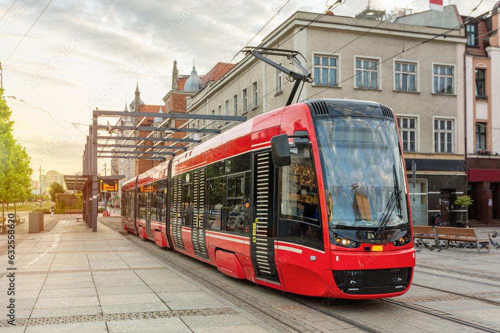 Red modern tram in the center of Katowice, Poland - obrazy, fototapety, plakaty 