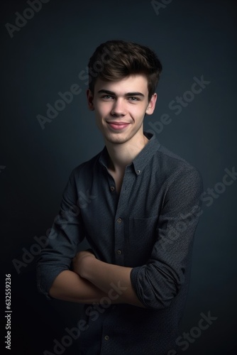 studio shot of a young man posing against a gray background