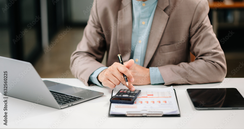 Close up of businessman or accountant hand typing laptop working to calculate on desk about cost at modern office.. Close up of businessman or accountant hand typing laptop working to calculate on desk about cost at modern office..