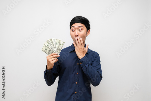 Positive asian man feels amazed look at lot of money in his hand islated