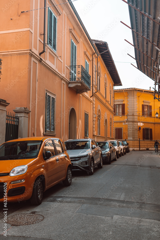 Street parking on the hill in old city. The street with ancient buildings in the center of Pisa, Italy. Photo of the facades of old buildings in the historic center. High quality photo