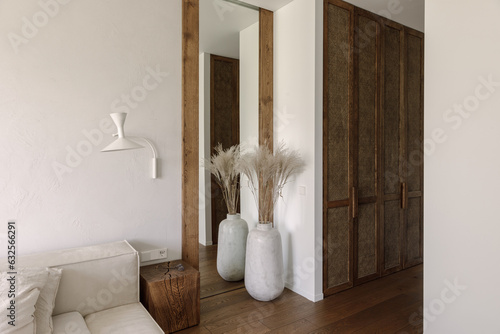 Aesthetic wabi sabi living room interior design in brown and off white shades with solid oak and rattan furniture. Wabi sabi inspiration. Slow living concept