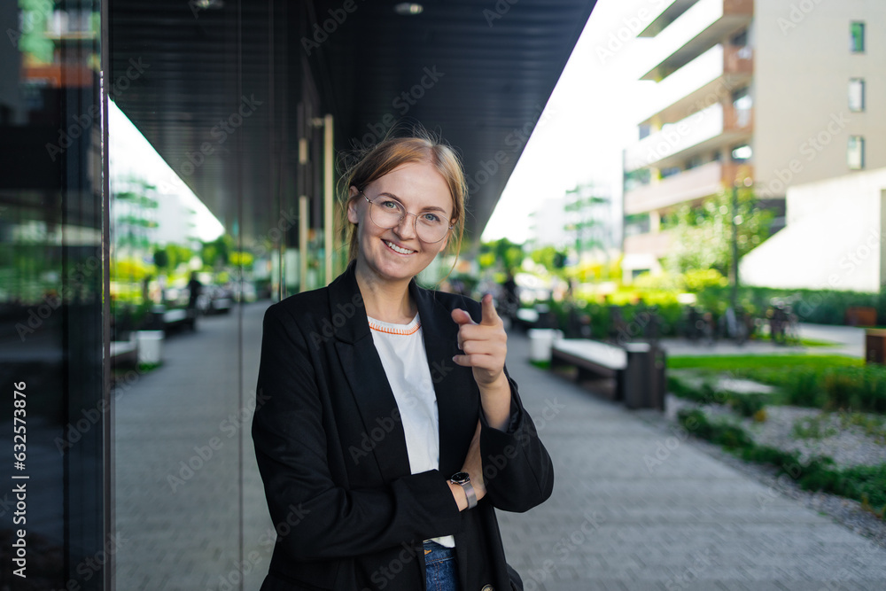 Happy business woman portrait of young female urban professional businesswoman in suit standing outside office buildings. Confident successful multicultural Caucasian woman. High quality photo Happy business woman portrait of young female urban professional businesswoman in suit standing outside office buildings. Confident successful multicultural Caucasian woman. High quality photo