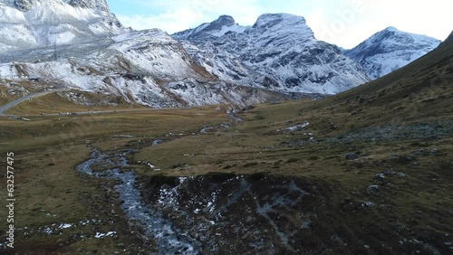 Young stream and first snow on the mountain peaks, drone image, Julierpass, Grisons, Switzerland, Europe photo