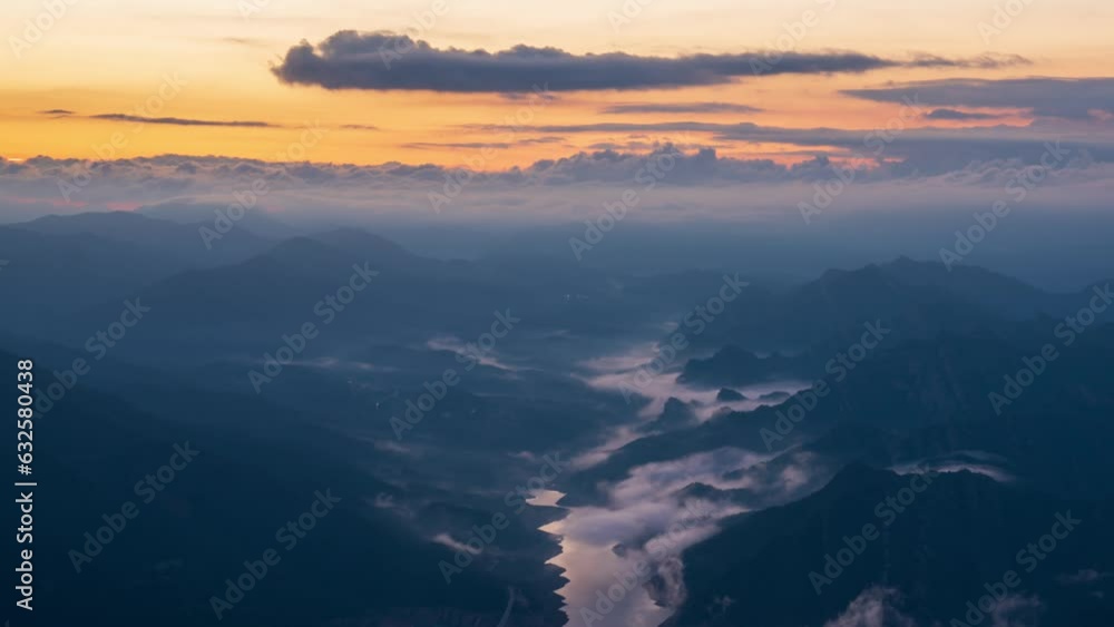 Berga, Catalunya, Spain. August 2022. Summer sunrise at the viewpoint of La Baells reservoir: moving clouds create a spectacle of light and shadow among the mountains. Berga, Catalunya, Spain. August 2022. Summer sunrise at the viewpoint of La Baells reservoir: moving clouds create a spectacle of light and shadow among the mountains.