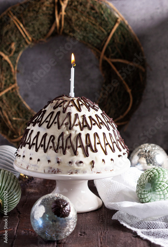 Pancho cake made of chocolate biscuit with sour cream and pineapple in New Year's or Christmas decoration. Rustic style.