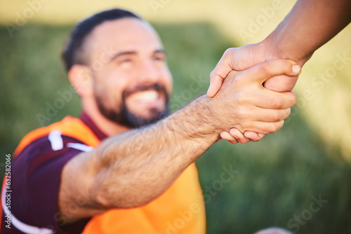 Fototapeta Naklejka Na Ścianę i Meble -  Hands, rugby and teamwork with a man helping a friend while training together on a stadium field for fitness. Sports, exercise and team building with an athlete and teammate outdoor for support
