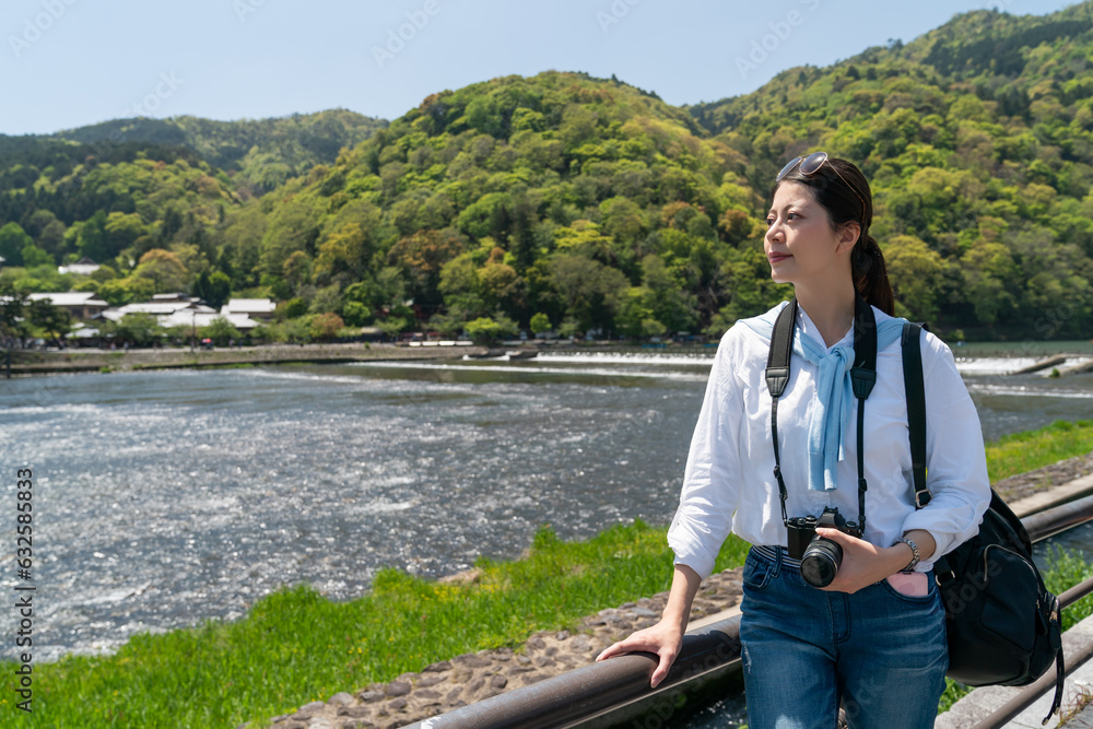 Φωτογραφία asian Japanese woman tourist enjoying natural beauty at riverside while relaxing