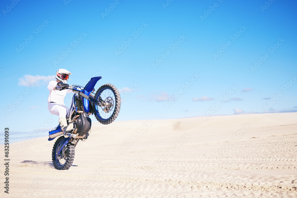 Fototapeta premium Bike, mockup and balance with a man in a desert for fitness or an adrenaline hobby on space. Motorcycle, skill and summer with a male sports athlete riding a vehicle in Dubai for freedom or energy