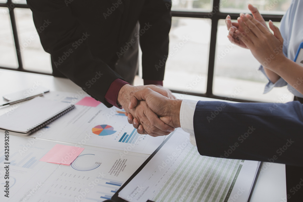 Business investor group holding hands, Two businessmen are agreeing on business together and shaking hands after a successful negotiation. Handshaking is a Western greeting or congratulation. Business investor group holding hands, Two businessmen are agreeing on business together and shaking hands after a successful negotiation. Handshaking is a Western greeting or congratulation.