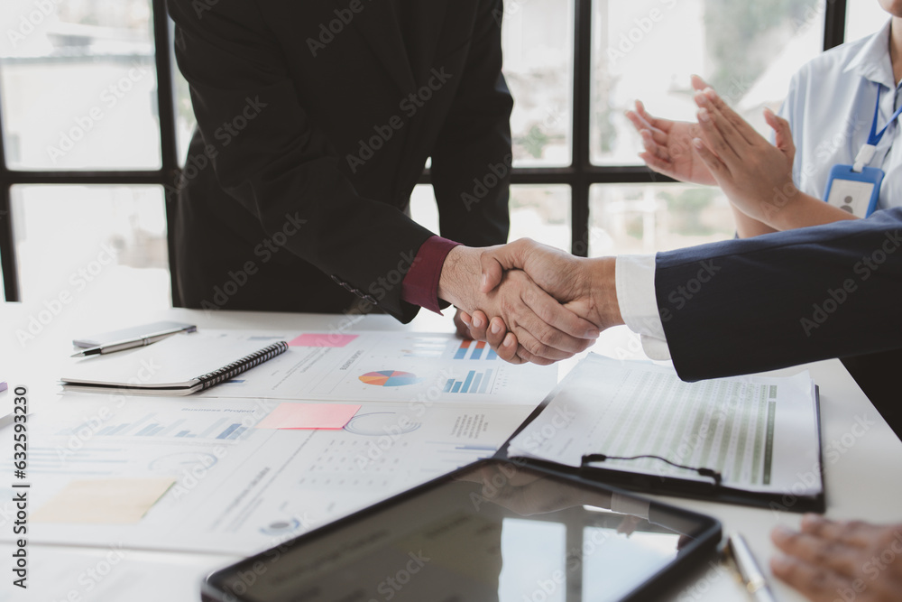 Business investor group holding hands, Two businessmen are agreeing on business together and shaking hands after a successful negotiation. Handshaking is a Western greeting or congratulation. Business investor group holding hands, Two businessmen are agreeing on business together and shaking hands after a successful negotiation. Handshaking is a Western greeting or congratulation.