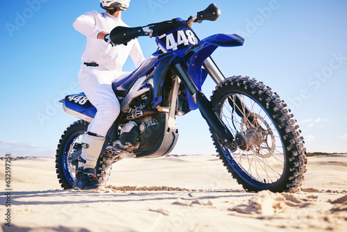 Sand, sports and man with motorbike in desert for adrenaline, adventure and freedom. Competition, extreme action and male person on bike on dunes for training, exercise and race for driving challenge