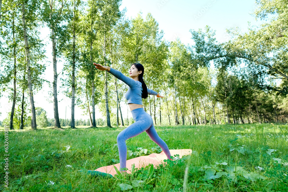 Portrait of a young woman doing yoga in the garden for a workout. Concept of lifestyle fitness and healthy. Asian women are practicing yoga in the park.