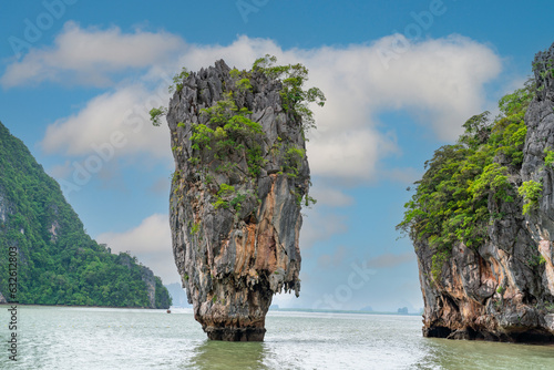 Famous James Bond island near Phuket in Thailand. Travel photo of James Bond island with thai traditional wooden longtail boat and beautiful sand beach in Phang Nga bay, Thailand. © frank29052515