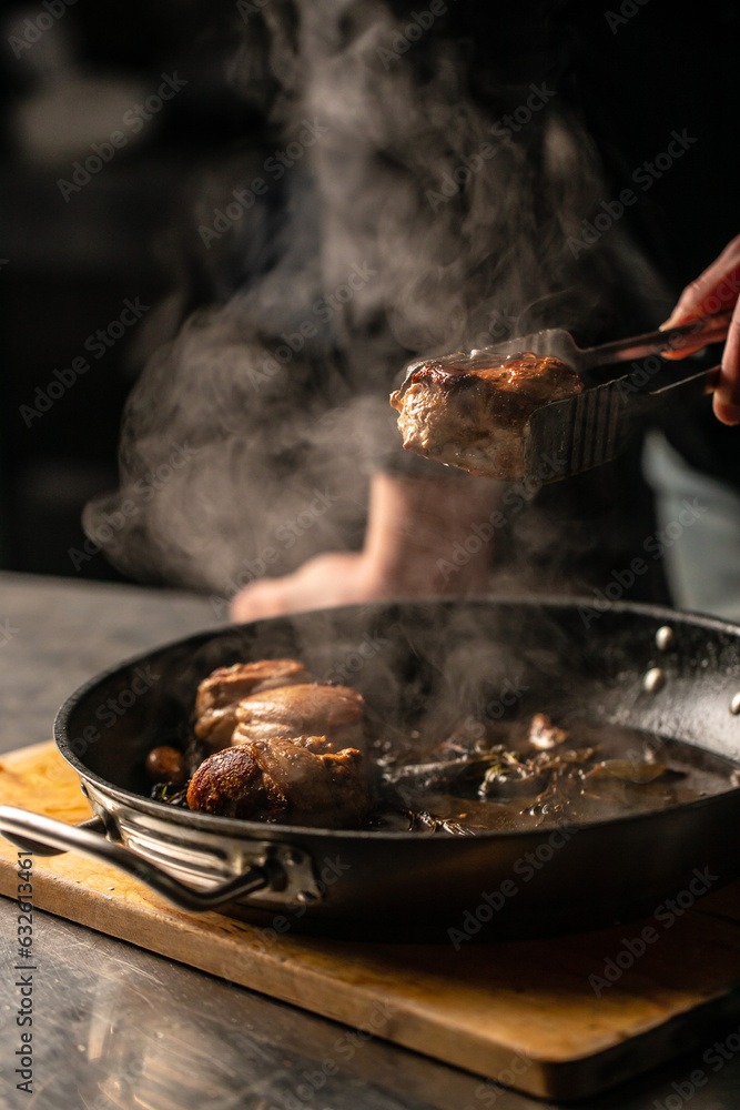 beef tenderloin steak is grilled in a grill pan with steaming. vertical image. top view. place for text beef tenderloin steak is grilled in a grill pan with steaming. vertical image. top view. place for text