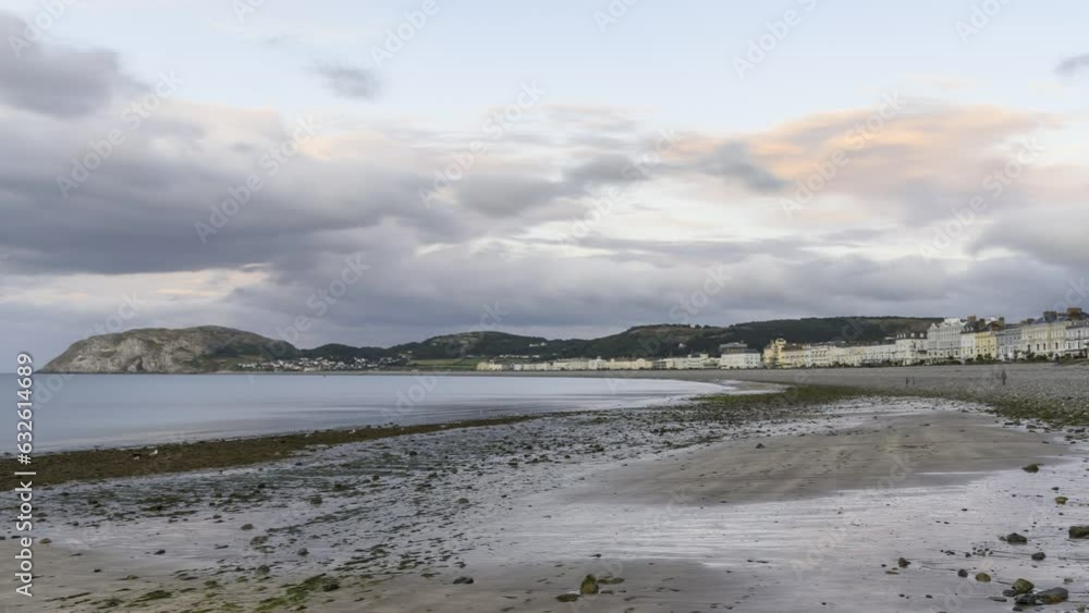 Passing clouds over a sandy beach in a seaside resort town at sunset in summer - time lapse Passing clouds over a sandy beach in a seaside resort town at sunset in summer - time lapse