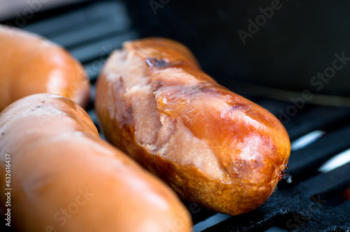 Grilled sausages on barbecue grill