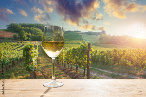 Barrel Wineglasses Cheese And Bottle In Vineyard At Sunset . High quality photo