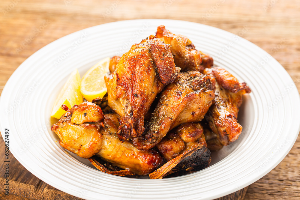 A plate of delicious lemon chicken wings A plate of delicious lemon chicken wings