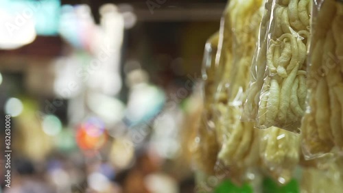 Dried fish maw in a plastic bag hanging at a dry food shop in Chinatown photo