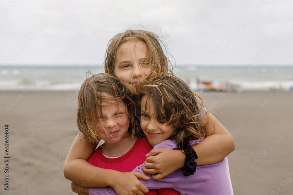 Cute smiling kid playing on the beach. Adorable young girls outdoors portrait
