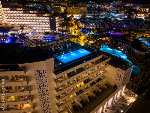 Canvas Print modern swimming pool with blue water illumination on hotel roof top, Tenerife